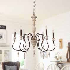 a chandelier hanging from the ceiling in a dining room