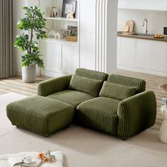 a green couch sitting on top of a living room floor next to a white rug