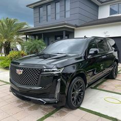 a black suv parked in front of a house