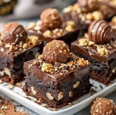 there are chocolate brownies with nuts on the top and one is cut in half