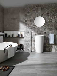 a bath room with a tub a mirror and a towel rack on the wall in front of it