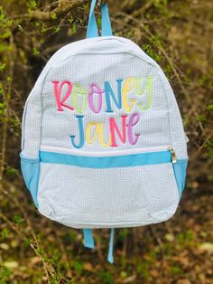 a backpack hanging from a tree with the words ronley jones on it's back