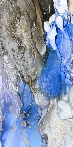 an abstract painting with blue and white colors on the rocks, water and ice in it