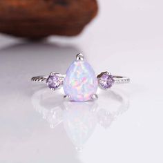 When it comes to the most stunning jewelry designs, we absolutely adore our gorgeous April Opal and Amethyst set. We've made each ring set with love by hand  using our premium sterling silver.  Finished with beautiful natural crystals, it's a design we know you will adore. ✦ DETAILS ✦ ✧ Purple fire opal and natural crystals  ✧ Sizes 3.75-11.25 ✧ This ring  will arrive ready to gift in a Kherish Jewelry Pouch. ✧ Due to the nature of the handmade process, each piece may slightly vary in color, size, shape, and contain natural inclusions. Every piece is gorgeous and one of a kind.  *Please refer to photos for reference.  ✦ This Artist Has Autism✦  Every item you order from Kherish is  handcrafted and packed by an artist with autism in RVA. Thanks to your support we are living our dreams.   Co Dainty Amethyst Jewelry In White Gold, Dainty Amethyst White Gold Jewelry, White Cubic Zirconia Jewelry For Birthday, Dainty White Gold Amethyst Jewelry, White Cubic Zirconia Birthday Jewelry, Dainty Purple Jewelry For Anniversary, Purple Dainty Jewelry For Anniversary, Lavender Birthstone Promise Ring, Lavender Birthstone Jewelry For Anniversary