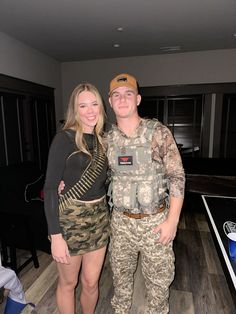 a man and woman standing next to each other in a room with hard wood floors