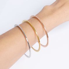 "This 18K Rose Gold Bangle Bracelet is the perfect accessory for class, style and minimalist sophistication. This bangle bracelet is great for everyday wear as a minimalist accent bracelet alone, or can be stacked for a unique and modern look. This bangle bracelet features smooth blank sides that can be engraved with \"hidden\" messages for unique personalized looks you can cherish for years to come. Its perfect for creating a personalized piece of jewelry that you can keep in your collection or Everyday Stackable Rose Gold Bangle, Modern Rose Gold Tarnish Resistant Bracelets, Modern Rose Gold Bangle, Modern Rose Gold Round Bangle, Modern Rose Gold Tarnish-resistant Bracelets, Modern Bangle Bracelet With Simple Design, Classic Rose Gold Bangle For Everyday Wear, Modern Simple Bangle Bracelet, Rose Gold Stackable Cuff Bracelet For Everyday