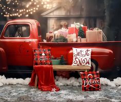 an old red truck with presents in the bed