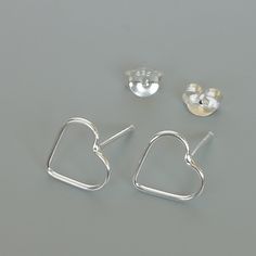 ONE PAIR of sterling silver heart ear studs. Dimensions: 10 x 9 Weight: 0.52 gm These earrings are made of 925 hypoallergenic sterling silver. Please note this price is for ONE PAIR only. All my pieces are sent in a gift box. I can include a personal message from you if needed You are welcome to contact me at... bhavnakwintra1956@gmail.com For more beautiful pieces from my shop, please browse 👇 TOE RINGS: https://www.etsy.com/your/shops/TheSilverGame/tools/listings/section:27020628,view:table E Modern Sterling Silver Heart Earrings For Gift, Modern Silver Heart Earrings For Gifts, Sterling Silver Minimalist Heart Earrings For Pierced Ears, Minimalist Sterling Silver Heart Earrings With Ear Wire, Sterling Silver Minimalist Heart Earrings, Minimalist Sterling Silver Heart Earrings, Silver Minimalist Earrings For Valentine's Day, Silver Open Heart Minimalist Earrings, Silver Minimalist Open Heart Earrings