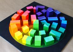 there are many different colored blocks in the shape of a circle on top of a table