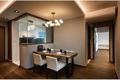 a dining room table with four chairs and a large mirror on the wall above it