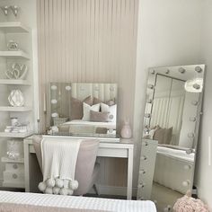 a bedroom with a bed, desk and mirror