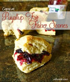 some biscuits with jam on them sitting on a counter