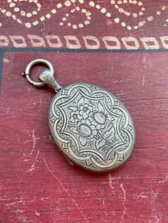 * Large antique late 1800's- early 1900's sterling silver floral picture locket with large clasp bail. * Not stamped or hallmarked, common for antique pieces. * Measurements- 3 inches in height including the bail, 2 inches without x 1.6 inches in width * Weight- 22.8 grams Please view and inspect the photos closely, as they are considered part of the condition. I endeavor to fully disclose all condition information clearly, however, please note that what qualifies as excellent condition for hist Ornate Engraved Medallion Locket Necklace, Antique Silver Engraved Locket Necklace For Memorial, Antique Sterling Silver Etched Locket Necklace, Engraved Antique Silver Locket Necklace For Memorial, Antique Etched Sterling Silver Locket Necklace, Antique Etched Locket Necklace For Memorial, Victorian Silver Locket Necklace, Victorian Antique Silver Stamped Jewelry, Victorian Style Stamped Antique Silver Jewelry