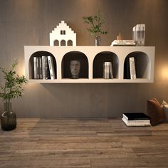 there is a shelf with books and vases on it in the living room area