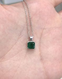 Featured is a stunning Asscher cut natural emerald necklace in fine .925 sterling silver. Displayed in the center is a dark-green emerald with very good clarity, accented by a simple four-prong silver mount, allowing for the emerald to be shown in full view. The earth mined emerald has a rich green color with excellent qualities. An 18-inch sterling silver chain will be provided with this beautiful pendant! This necklace is ideal for everyday use and is the perfect accessory to any outfit. The p Emerald Rings Silver, Emerald Necklace Silver, Hallmarked Round Emerald Necklace, Formal Emerald Necklace With Square Pendant, Fine Jewelry With Polished Emerald Finish, Silver Pendant Emerald Necklace, Emerald Pendant Necklace With Diamond Cut, Green Diamond Cut Emerald Pendant Necklace, Sterling Silver Emerald Pendant Necklace For Formal Events