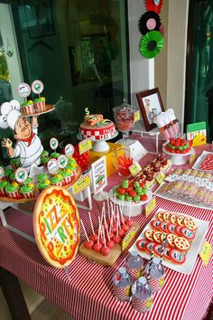 a red and white table topped with lots of food