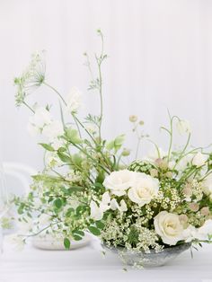 a vase filled with white flowers on top of a table