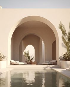 an outdoor swimming pool with lounge chairs and potted plants next to it in front of a white stucco wall