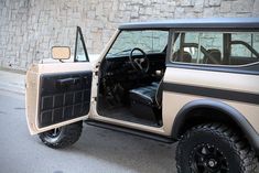 an old jeep with its door open and the driver's seat in place to sit