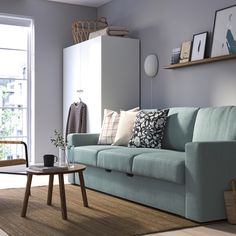 a living room with a blue couch and coffee table in front of a large window