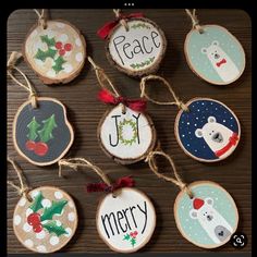 christmas ornaments are hanging on a wooden table