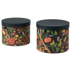 two black boxes with oranges and other fruit designs on the sides, one has a lid