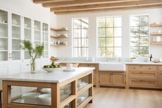 a kitchen filled with lots of white counter tops