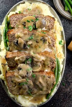 meatloaf with mushroom gravy on mashed potatoes and asparagus