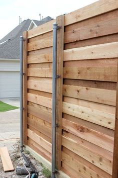 a wooden fence is being built in front of a house