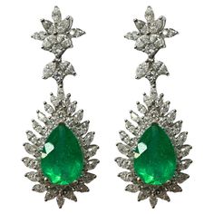 Indulge in luxury with these 18k Diamond and Pear Cut Emerald Earrings. Each earring features a stunning 7.73 carat pear cut emerald surrounded by sparkling 4.61 carat marquise cut diamonds and 1.72 carat diamond accents. Made of 18k white gold, these earrings are in good condition for their age. Elevate your style with these elegant and eye-catching earrings. 18k Diamond and Pear Cut Emerald Earrings Condition: In good condition with some minor surface wear consistent with age. Length: 1.8 inches Metal: 18k White Gold Weight: 17.9 grams Marquise Cut Diamonds: 4.61 carats Diamond Accents: 1.72 carats Pear Cut Emerald: 7.73 carats Pear Cut Diamond Earrings, Pear Diamond Earrings, Earring Video, Pear Cut Diamond, Marquise Cut Diamond, Ruby Earrings, Diamond Drop Earrings, White Gold Earrings, Emerald Earrings