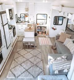 the interior of a mobile home with white walls and wood floors