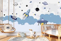 a child's room decorated in blue and white with space themed wall decals