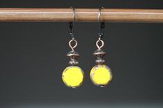 "Yellow Earrings Czech Glass Earrings Dangle Drop Earrings Gift for women Birthday Gifts for women Gift For her Yellow dangle earrings made with Czech glass coin beads with antique copper accent tones. These earrings are small and lightweight, comfortable and easy to wear everyday. Leverbacks keep your earrings on securely by creating a closed loop. Color : Yellow coin, Czech glass beads  Finish : Antiqued copper findings Size : 1 inches including the antique copper lever backs Ear wires : Antique copper lever backs Czech Glass Earrings : https://www.etsy.com/shop/NtikArtJewelry?ref=hdr_shop_menu§ion_id=16062218 To visit my shop : https://www.etsy.com/shop/NtikArtJewelry I usually ship between 1 and 3 business day with USPS first class. If you need an order sooner you can still select a pr Yellow Dangle Earrings With Lever Back, Women Birthday Gifts, Copper Accents, Yellow Earrings, Women Birthday, Lightweight Earrings, Birthday Woman, Small Earrings, Light Weight Earrings