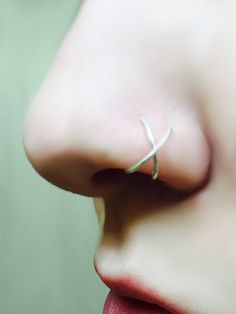 a woman with a nose ring on her nose