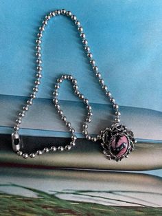 "Vintage Rhodonite Gemstone in a Silver Articulated leaf pattern setting Brooch converted to a Pendant. This gemstone pin had a jump attached to it to put the ball chain through to wear as a necklace. The ball chain is 18\" and is stainless steel. The rhodonite brooch is 1 1/8\" in height and 1\" in width.  Such a pretty gemstone! Free Shipping in the U.lS> when Purchasing $35 or more. Complementary Vintage Gift Wrap on this Item. There are No Returns or Exchanges on this Item." 50s Jewelry, Rhodonite Jewelry, Pink Pendant Necklace, Pink Stone Necklace, 80s Jewelry, Oval Locket, Locket Pendant Necklace, Jewelry Lockets, Teardrop Dangle Earrings