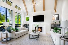 a living room filled with furniture and a flat screen tv mounted to the wall above a fireplace