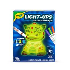 the light - up toy is in its box with markers and markers on it's side