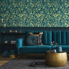 a living room with blue couches and green wallpaper