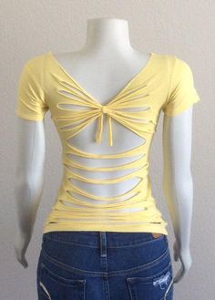 a mannequin wearing a yellow top with cutouts on the front and back