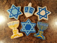 decorated cookies in the shape of hanukkah, menorah and star of david