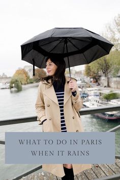 a woman holding an umbrella over her head with the words what to do in paris when it rains