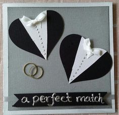 a wedding card with two black and white heart shaped pieces on top of each other