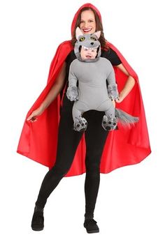 a woman in a costume with a cat on her chest and a red cape over her shoulders