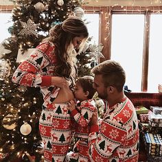 a woman and two men in matching christmas pajamas