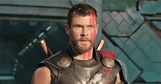 a man dressed as thor from the avengers movie, holding two swords in his hand