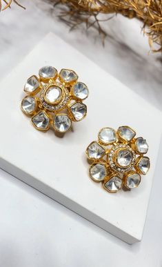 Embrace the timeless beauty of traditional Indian jewelry with our "Timeless Beauty" Uncut Kundan Polki Stud Earrings, meticulously crafted in brass. These stud earrings pay homage to the opulence of uncut Kundan and the rich heritage of Indian craftsmanship. They are the perfect choice for adding a touch of traditional elegance to your attire, whether it's for weddings, special occasions, or cultural celebrations. Materials: Brass: The earrings are skillfully made from brass, reflecting the dep Temple Jewelry Earrings With Mirror Work For Wedding, Temple Jewelry Bridal Earrings With Mirror Work For Diwali, Elegant Gota Work Earrings For Navratri, Festive Bridal Earrings With Gota Work, Festive Bridal Earrings With Mirror Work, Gold Temple Jewelry Bridal Earrings With Mirror Work, Gold Bridal Earrings With Mirror Work In Temple Style, Silver Bridal Earrings With Gota Work For Diwali, Traditional Gold Bridal Earrings With Mirror Work