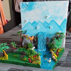 a cake with a waterfall and trees on it's side that is made to look like an island