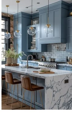 a kitchen with blue cabinets and marble counter tops in the center, along with three bar stools