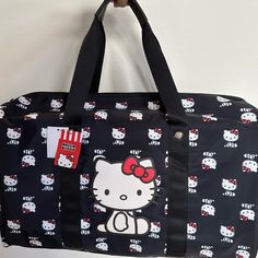 Spacious Hello Kitty Bioworld Duffel Bag Perfect To Use As A Carry On Rectangular Hello Kitty Shoulder Bag For Travel, Hello Kitty Print Shoulder Bag For Travel, Travel Rectangular Bag With Hello Kitty Print, Hello Kitty Print Travel Shoulder Bag, Cute Hello Kitty Shoulder Bag For Travel, Casual Travel Bag With Cat Design, Casual Hello Kitty Bags For Daily Use, Casual Hello Kitty Print Bags For Shopping, Casual Hello Kitty Everyday Bags