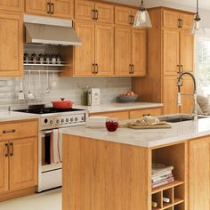 a kitchen with wooden cabinets and white counter tops